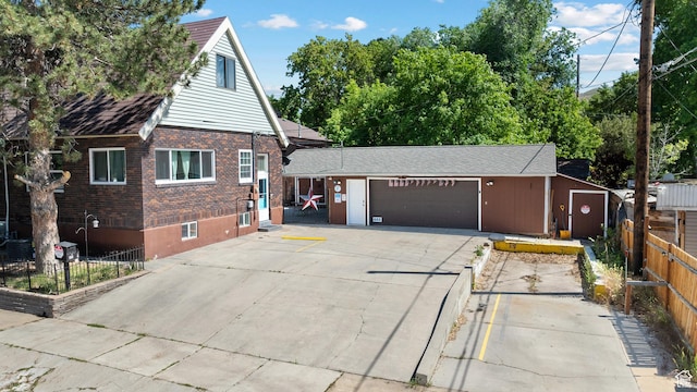 160 S 200 W, Tooele, UT 84074 - view of front of house featuring brick siding, a garage, and concrete driveway