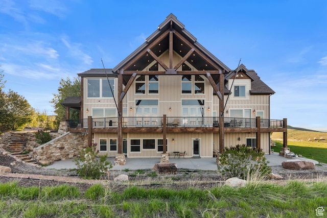 1560 Reserve Dr, Fish Haven, ID 83287 - back of property featuring a patio, a balcony, and board and batten siding