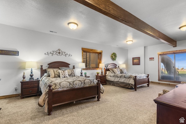 1560 Reserve Dr, Fish Haven, ID 83287 - bedroom with light carpet, beamed ceiling, baseboards, and a textured ceiling