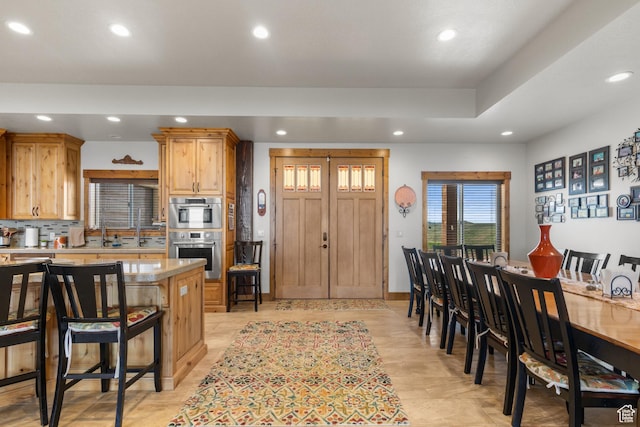 1560 Reserve Dr, Fish Haven, ID 83287 - kitchen featuring recessed lighting, light countertops, a breakfast bar, and stainless steel double oven