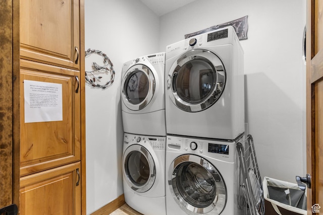 1560 Reserve Dr, Fish Haven, ID 83287 - laundry area featuring stacked washer and clothes dryer and cabinet space