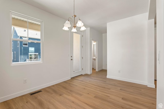 6658 W 11800 S, South Jordan, UT 84009 - unfurnished room featuring a chandelier, wood finished floors, and baseboards