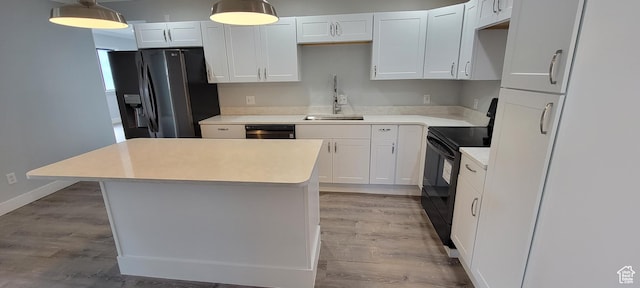 325 W Apple St, Grantsville, UT 84029 - kitchen with black range with electric cooktop, a sink, stainless steel refrigerator with ice dispenser, light wood-type flooring, and a center island