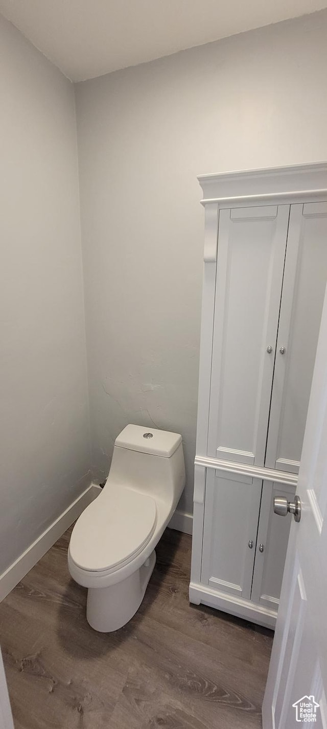 325 W Apple St, Grantsville, UT 84029 - bathroom featuring wood finished floors, toilet, and baseboards