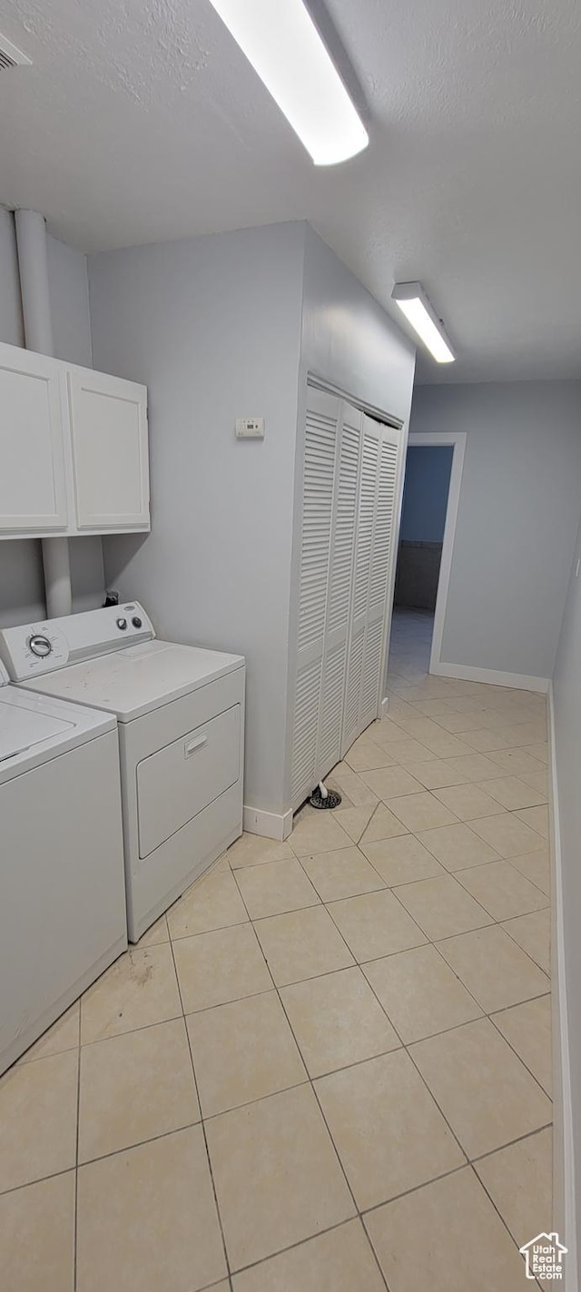 325 W Apple St, Grantsville, UT 84029 - laundry area featuring cabinet space, washing machine and dryer, baseboards, light tile patterned floors, and a textured ceiling