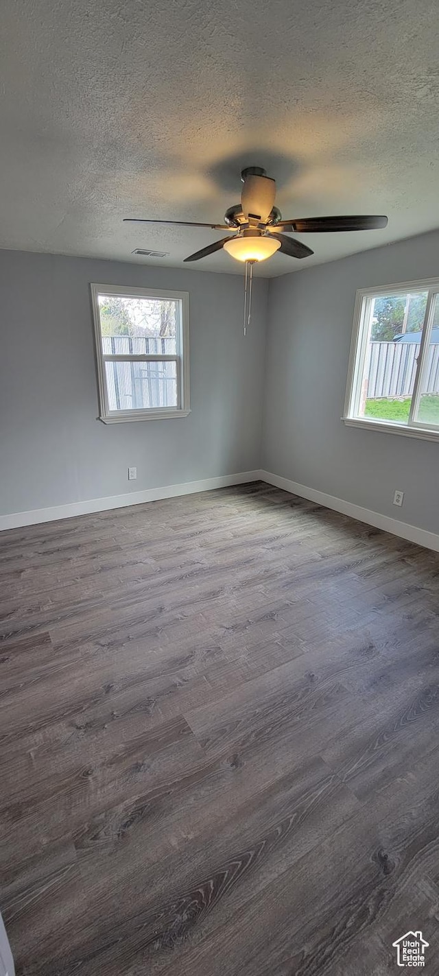 325 W Apple St, Grantsville, UT 84029 - unfurnished room featuring ceiling fan, wood finished floors, a textured ceiling, and baseboards