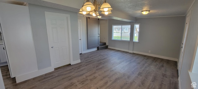 325 W Apple St, Grantsville, UT 84029 - unfurnished dining area with a chandelier, dark wood-type flooring, baseboards, a textured ceiling, and stairs