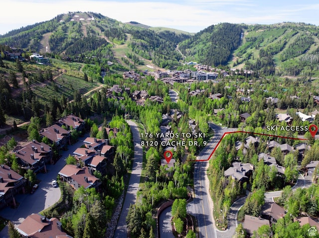 8120 Cache Dr Unit 9, Park City, UT 84060 - aerial view of property's location with a mountainous background, property boundaries highlighted, nearby suburban area, and a forest