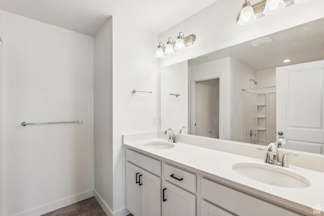 6656 W 11800 S Unit 619, South Jordan, UT 84009 - bathroom featuring double vanity, baseboards, and a shower