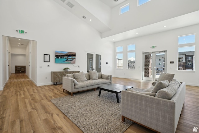 3722 W 1440 N Unit F301, Lehi, UT 84043 - living area with a high ceiling, light wood-style floors, plenty of natural light, baseboards, and recessed lighting