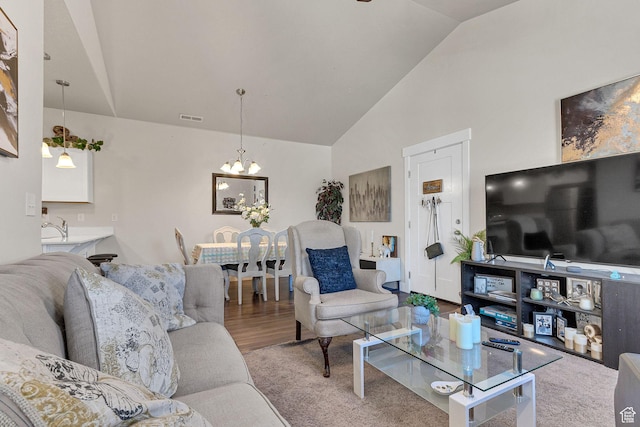 3722 W 1440 N Unit F301, Lehi, UT 84043 - carpeted living room with a chandelier, a sink, and high vaulted ceiling