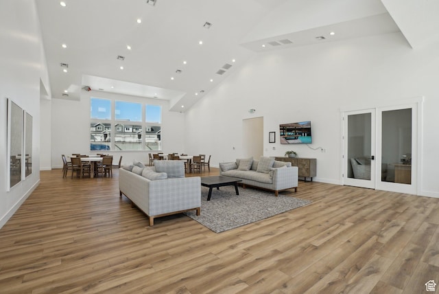 3722 W 1440 N Unit F301, Lehi, UT 84043 - living room with high vaulted ceiling, light wood finished floors, french doors, and recessed lighting