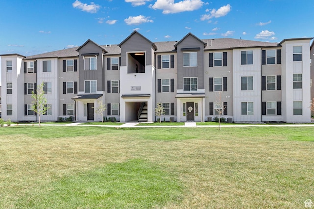 3722 W 1440 N Unit F301, Lehi, UT 84043 - view of front of property featuring a front lawn, stucco siding, and board and batten siding