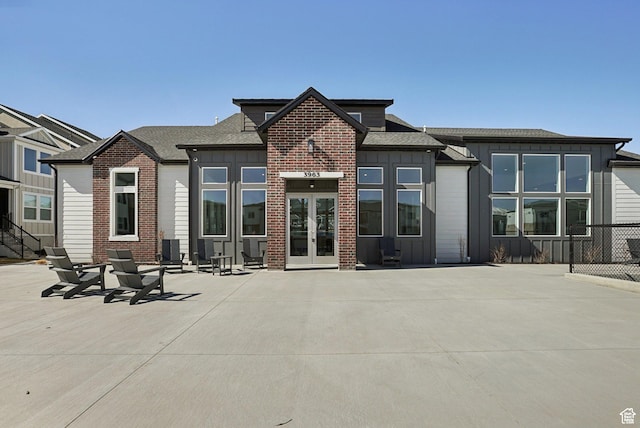 3722 W 1440 N Unit F301, Lehi, UT 84043 - rear view of property with board and batten siding, french doors, a shingled roof, and brick siding