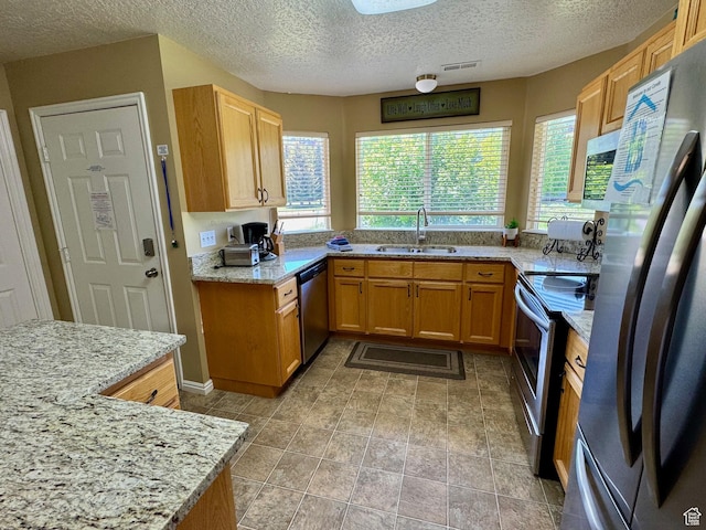 815 N Harbor Dr Unit 201, Garden City, UT 84028 - kitchen with stainless steel appliances, a textured ceiling, and light stone counters