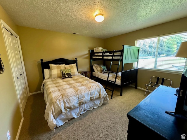 815 N Harbor Dr Unit 201, Garden City, UT 84028 - bedroom featuring carpet flooring, a textured ceiling, and a closet