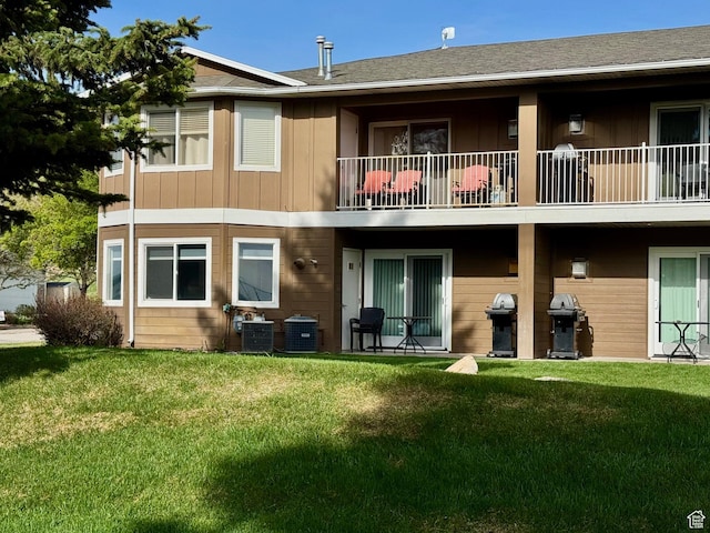 815 N Harbor Dr Unit 201, Garden City, UT 84028 - rear view of property with a balcony, a yard, and board and batten siding