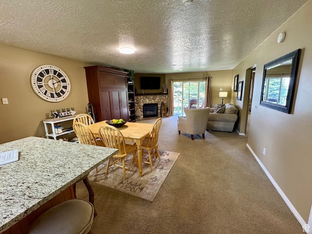 815 N Harbor Dr Unit 201, Garden City, UT 84028 - dining room with a textured ceiling, a stone fireplace, and light carpet