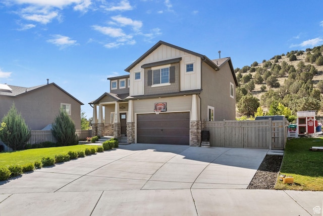 4114 E Cherokee St, Eagle Mountain, UT 84005 - craftsman inspired home with stone siding, concrete driveway, board and batten siding, and a garage