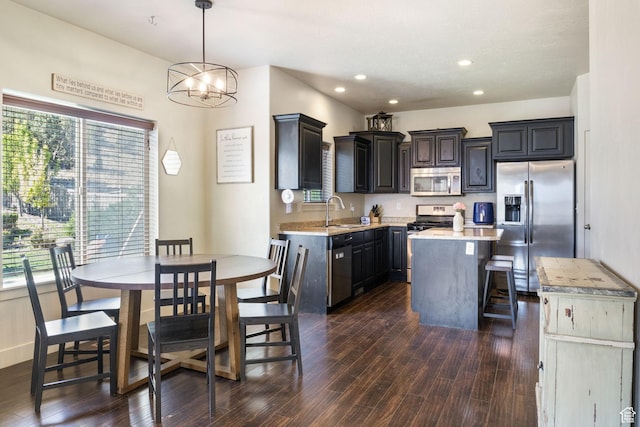 4114 E Cherokee St, Eagle Mountain, UT 84005 - kitchen featuring stainless steel appliances, a sink, light countertops, dark wood-type flooring, and recessed lighting