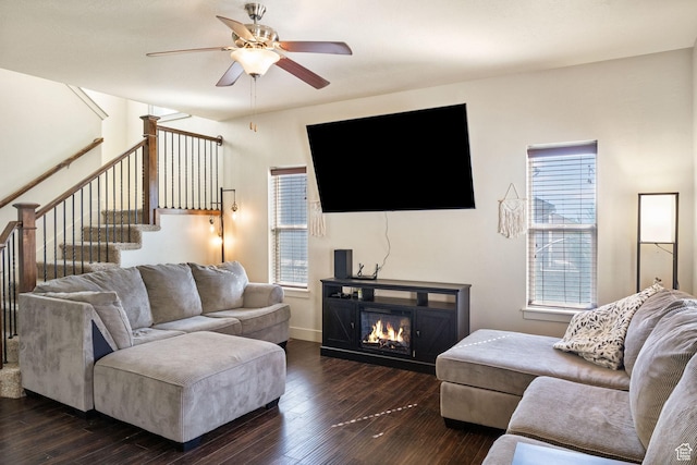 4114 E Cherokee St, Eagle Mountain, UT 84005 - living room with a ceiling fan, dark wood-style flooring, a glass covered fireplace, and stairs