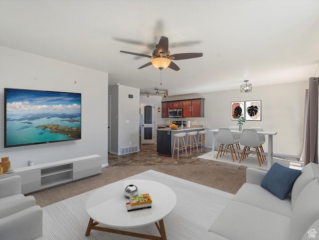 8052 N Clearwater Rd, Eagle Mountain, UT 84005 - carpeted living area with a ceiling fan and baseboards