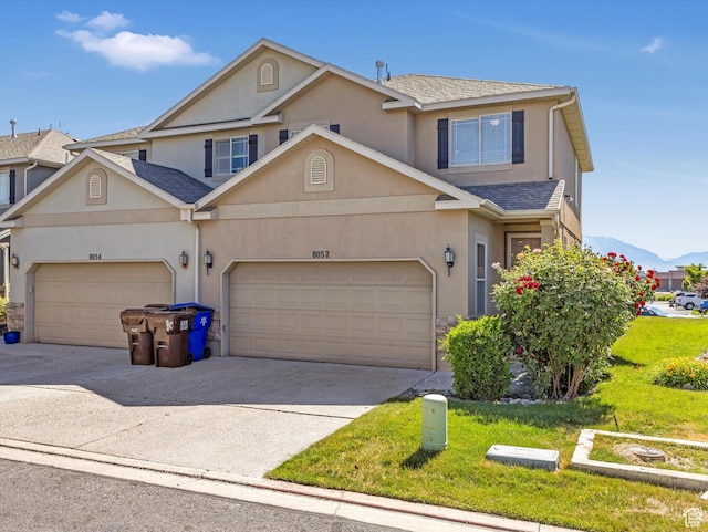 8052 N Clearwater Rd, Eagle Mountain, UT 84005 - traditional-style home with concrete driveway, stucco siding, a garage, a front lawn, and a shingled roof
