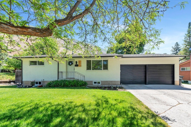256 N 1040 E, Springville, UT 84663 - ranch-style home featuring brick siding, a garage, concrete driveway, and a front lawn