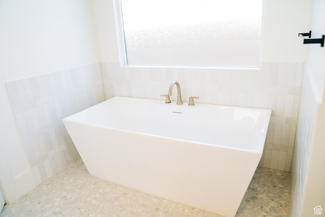 2775 S Rowan Ln, St George, UT 84790 - full bathroom with tile walls, a freestanding tub, and wainscoting
