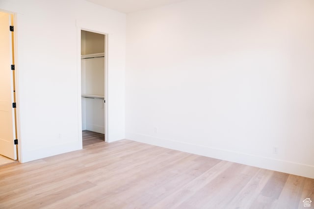 2775 S Rowan Ln, St George, UT 84790 - unfurnished bedroom with light wood-style floors, a spacious closet, baseboards, and a closet