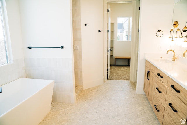 2775 S Rowan Ln, St George, UT 84790 - bathroom featuring plenty of natural light, a soaking tub, vanity, and tiled shower