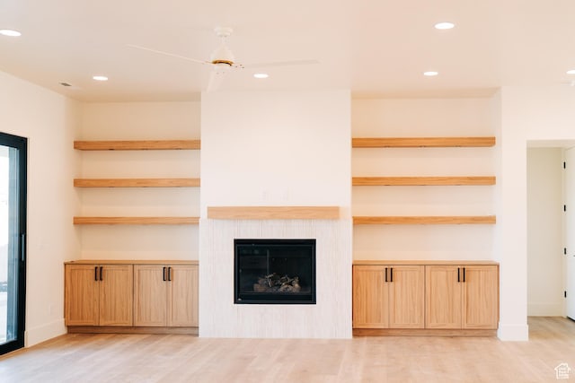 2775 S Rowan Ln, St George, UT 84790 - unfurnished living room with light wood-style floors, recessed lighting, and a tiled fireplace