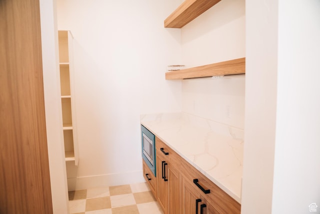 2775 S Rowan Ln, St George, UT 84790 - bar featuring stainless steel microwave, light flooring, and baseboards