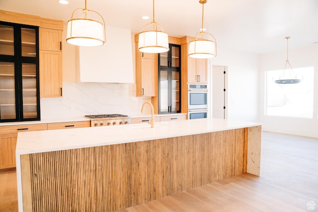 2775 S Rowan Ln, St George, UT 84790 - kitchen with a sink, appliances with stainless steel finishes, light wood finished floors, an island with sink, and light countertops