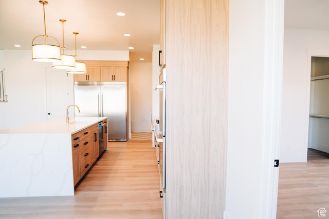 2775 S Rowan Ln, St George, UT 84790 - kitchen featuring built in refrigerator, light brown cabinets, light wood finished floors, recessed lighting, and decorative light fixtures