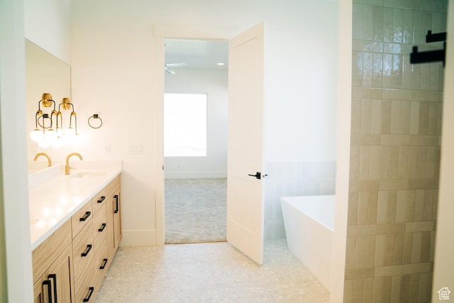 2775 S Rowan Ln, St George, UT 84790 - bathroom featuring double vanity, a freestanding tub, ceiling fan, and tile patterned flooring