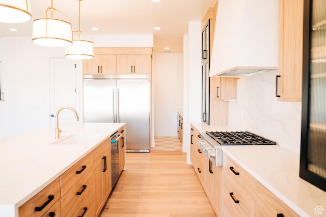 2775 S Rowan Ln, St George, UT 84790 - kitchen with custom range hood, built in refrigerator, a sink, light brown cabinets, and gas cooktop
