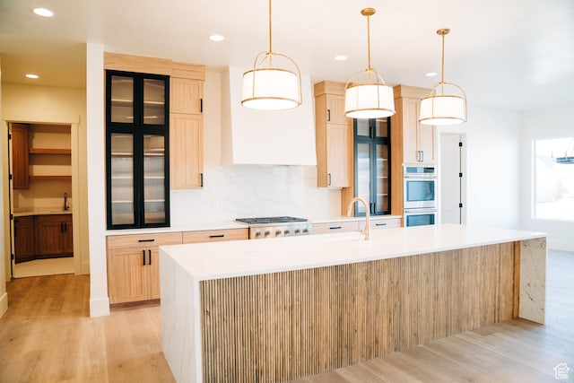 2775 S Rowan Ln, St George, UT 84790 - kitchen featuring stainless steel double oven, light wood finished floors, a kitchen island with sink, a sink, and recessed lighting