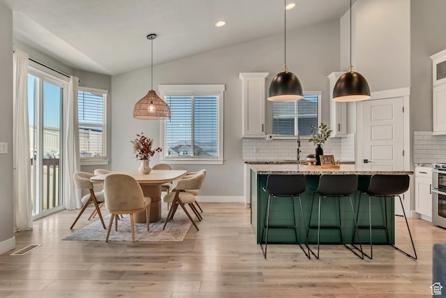 3041 S Hollow Way, Saratoga Springs, UT 84045 - dining space featuring lofted ceiling, light wood-style floors, baseboards, and recessed lighting