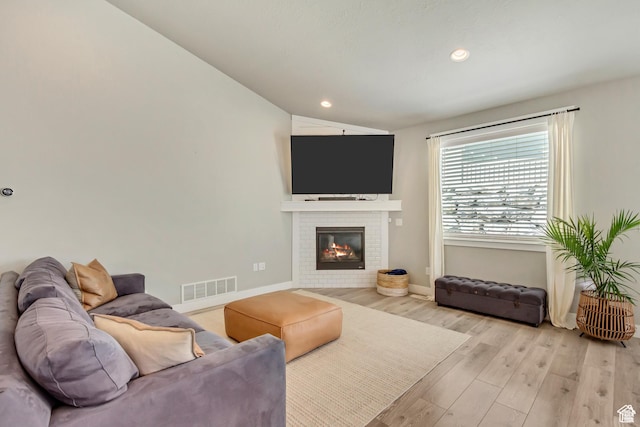 3041 S Hollow Way, Saratoga Springs, UT 84045 - living room featuring light wood finished floors, baseboards, a brick fireplace, vaulted ceiling, and recessed lighting