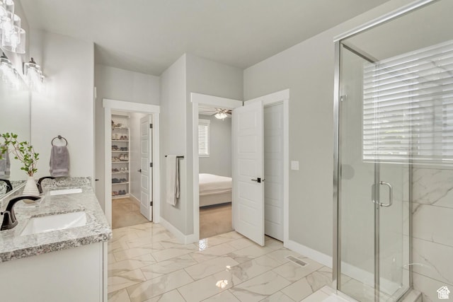 3041 S Hollow Way, Saratoga Springs, UT 84045 - ensuite bathroom featuring marble look tile flooring, double vanity, a shower stall, a ceiling fan, and a walk in closet