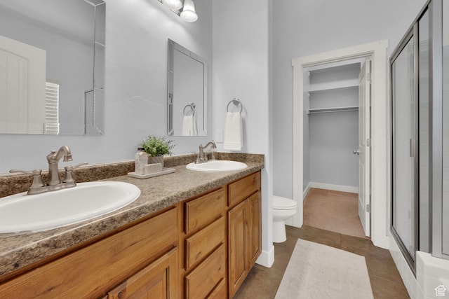 10756 S Navarro Way W, South Jordan, UT 84009 - full bath featuring a stall shower, double vanity, toilet, a spacious closet, and tile patterned floors