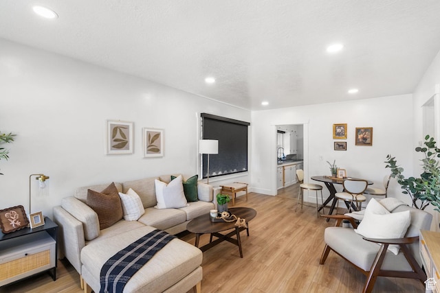 1022 27th St S, Ogden, UT 84403 - living room featuring light wood-style floors, recessed lighting, and baseboards