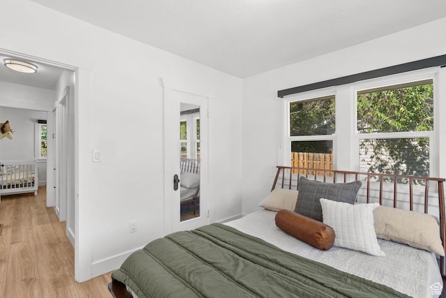 1022 27th St S, Ogden, UT 84403 - bedroom featuring multiple windows, light wood finished floors, and baseboards