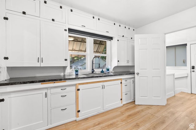 1022 27th St S, Ogden, UT 84403 - kitchen with a sink, white cabinets, and light wood-type flooring