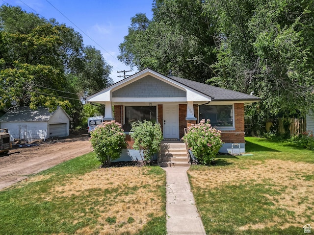 1022 27th St S, Ogden, UT 84403 - bungalow-style house with brick siding, a front lawn, covered porch, and dirt driveway