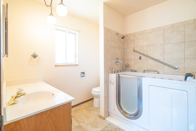 649 W Bulldog Cir, Murray, UT 84123 - bathroom featuring washer / clothes dryer, vanity, toilet, and baseboards