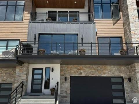795 E Miner Way, Hideout, UT 84036 - back of property with a balcony, an attached garage, and stone siding