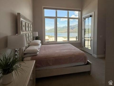 795 E Miner Way, Hideout, UT 84036 - bedroom featuring multiple windows, baseboards, carpet, and a water view