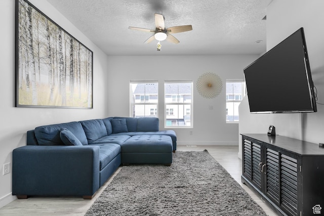 347 N 750 E, Vineyard, UT 84059 - living area featuring a ceiling fan, a textured ceiling, healthy amount of natural light, light wood-style flooring, and baseboards